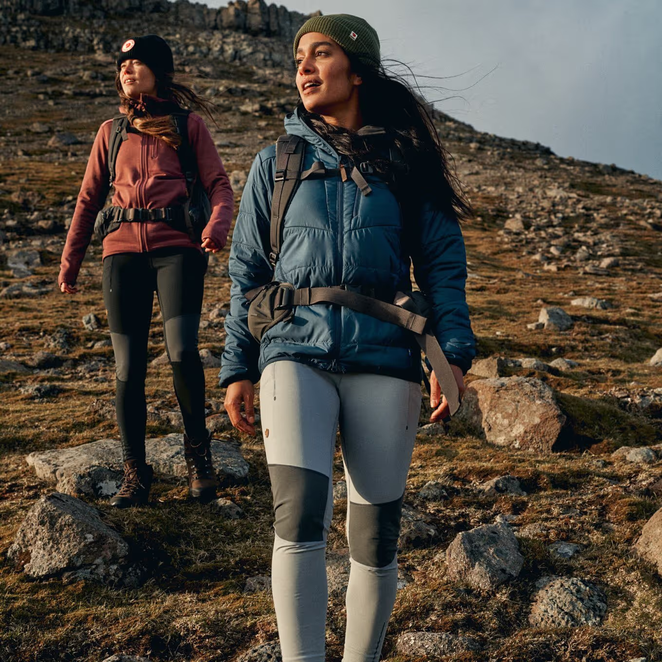 two hikers walking across an open space