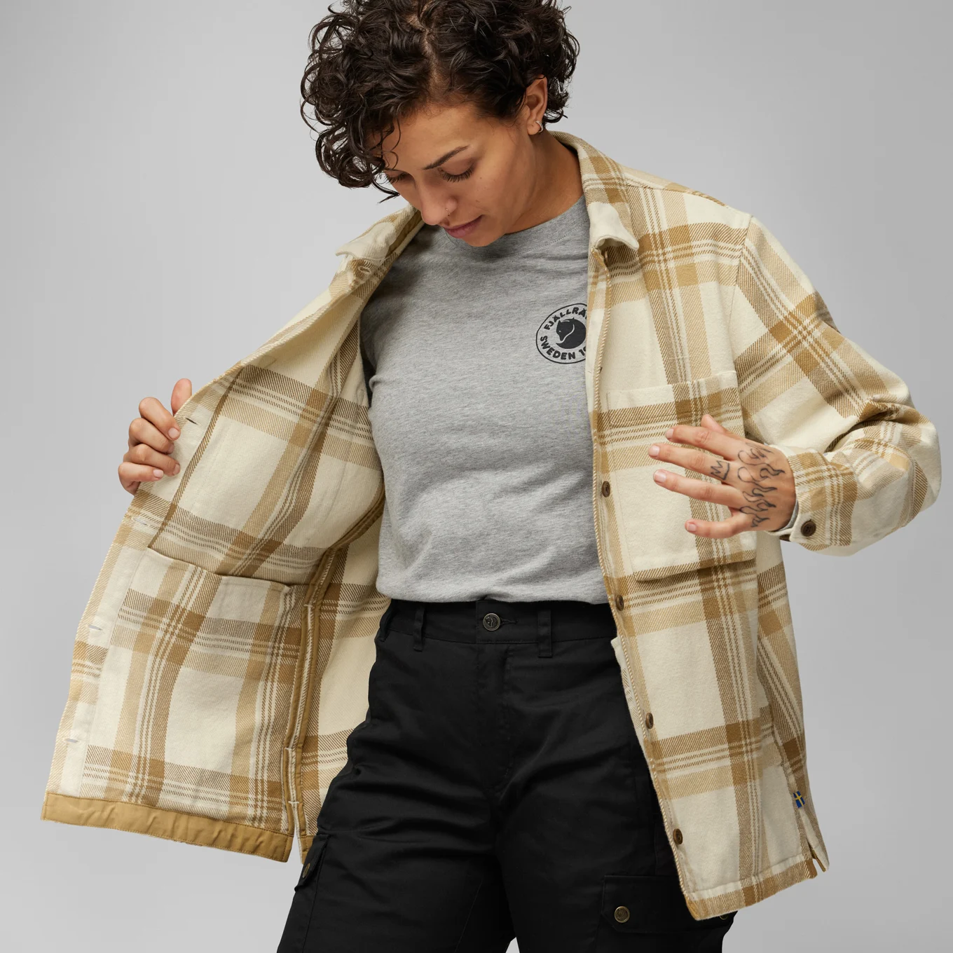 woman wearing a checked overshirt by Fjallraven